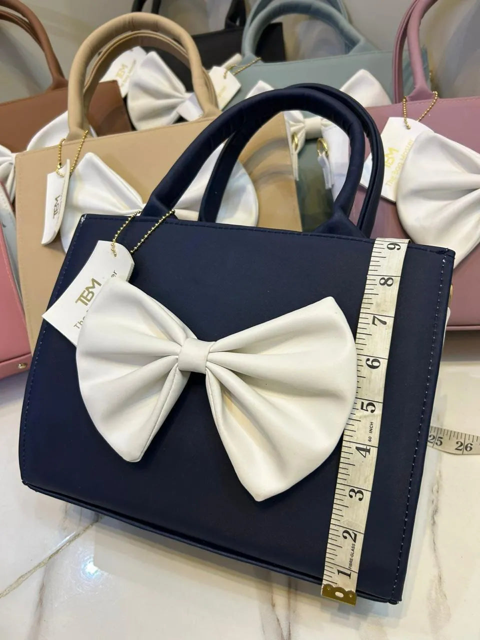 Women leather shoulder bag by Swift Mart with white bow stylish design for casual and formal use